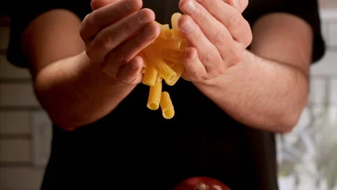 Man dropping pasta for cooking Stock Footage 156845996