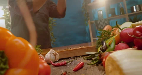 Man dropping sliced vegetables on board Stock Footage 311833517
