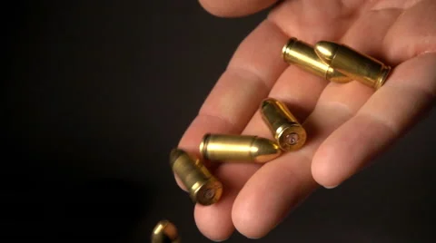 Man drops bullets, slow motion Stock Footage 61696137