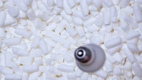 Man drops matte light bulb into a box of soft filler and foam sticks Stock Footage 197571794