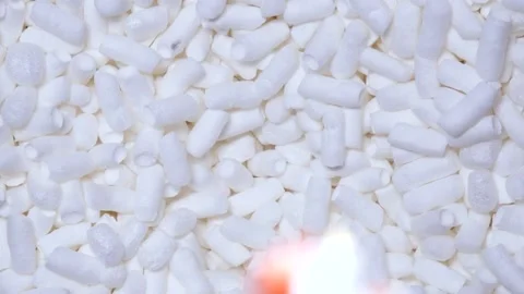 Man drops old statue into a box of soft filler and foam sticks in slow motion. Stock Footage 197572607