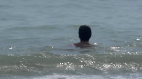 Man drowning in the sea hand asking for help sticking out of foamy water Video stock 77780203