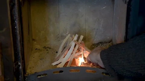 The man drowns the fireplace. Stock Footage 103617046
