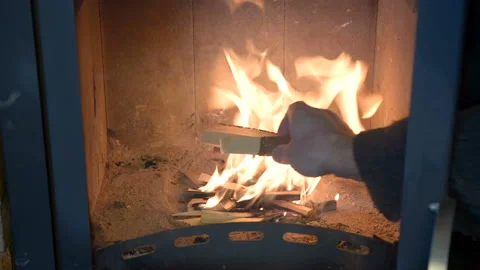 The man drowns the fireplace. Stock Footage 103617121