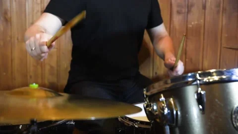 Man drummer with drumsticks playing drums and cymbals Stock Footage