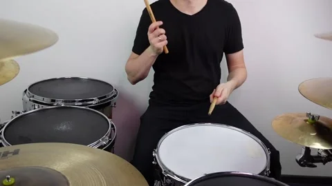 Man drummer with drumsticks playing drums Stock Footage 147940964