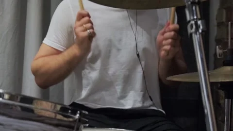 Man drummer hits drum kit in dark music studio. Creates music and art. Drum set Stock Footage 317490790