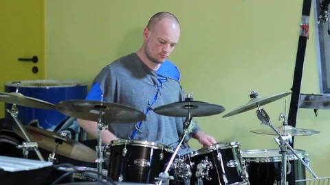 Man Drummer playing his black Drum kit with many cymbals Stock Footage 104855136