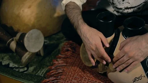 Man drumming out a beat on an arabic percussion drum named Frudu Stock Footage 74519928