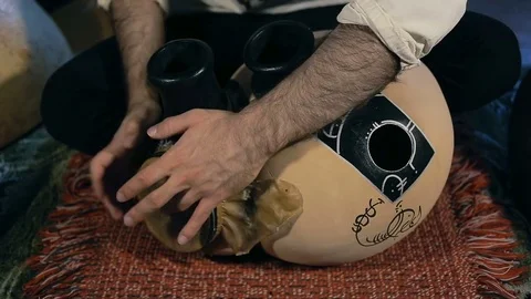 Man drumming out a beat on an arabic percussion drum named Frudu Stock Footage 74520295