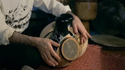 Man drumming out a beat on an arabic percussion drum named Frudu Stock Footage 74520607