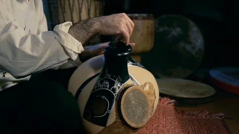 Man drumming out a beat on an arabic percussion drum named Frudu Stock Footage 74520703