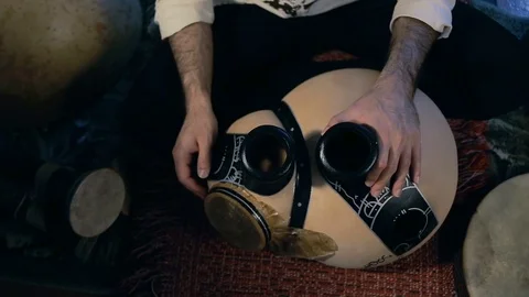 Man drumming out a beat on an arabic percussion drum named Frudu Stock Footage 74520820