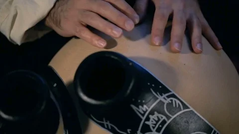 Man drumming out a beat on an arabic percussion drum named Frudu Stock Footage 74522542