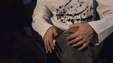 Man drumming out a beat on an arabic percussion drum named Tombak at home. Stock Footage 74522667