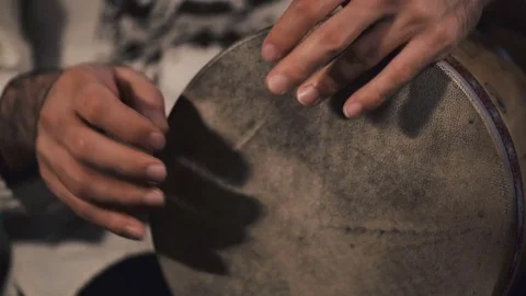 Man drumming out a beat on an arabic percussion drum named Tombak at home. Stockbeeldmateriaal 74523655
