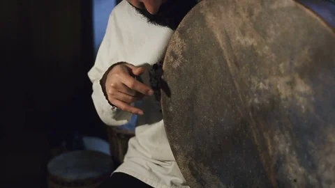 Man drumming out a beat on an arabic percussion drum named Bendir at home. Video stock 74525330