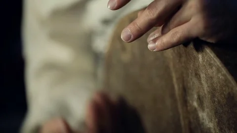 Man drumming out a beat on an arabic percussion drum named Bendir at home. Stock Footage 74525503