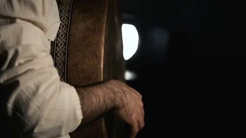 Man drumming out a beat on an arabic percussion drum named Bendir at home. Stock Footage 74525602