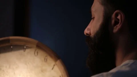 Man drumming out a beat on an arabic percussion drum named Dayereh at home. Video stock 74525763