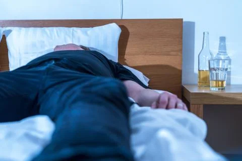 A man is drunk on the bed Stock Photos