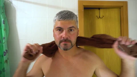 Man drying himself off with a brown towel 4K Stock-Footage 156772109