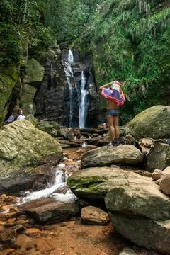 Man drying himself with towel after bathing on rainforest waterfall Stock Photos