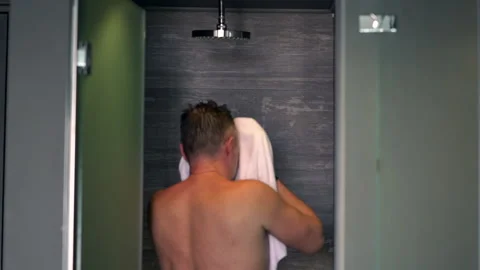 Man drying his face on a towel after showering Stock-Footage 158929362