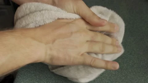 A man is drying his wet hands with a towel in close-up lifestyle Stock Footage 232350959
