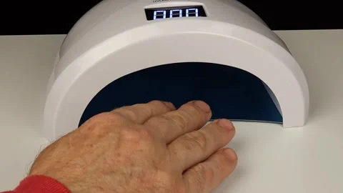 Man Drying Nails In Lamp Stock Footage 297081440