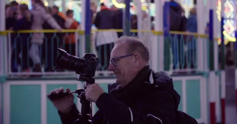 Man with DSLR camera and tripod Making a photo Stock Footage 56835908