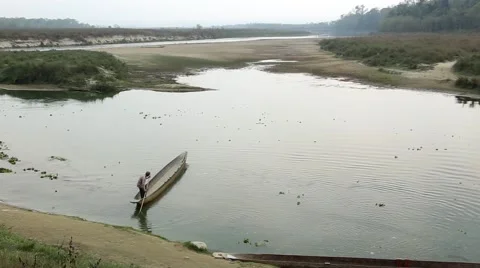 Man on a dug out Canoe Stock Footage 65775666