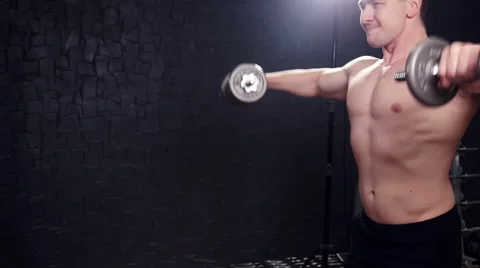 A man with a dumbbell in the gym Stock-Footage 68078700
