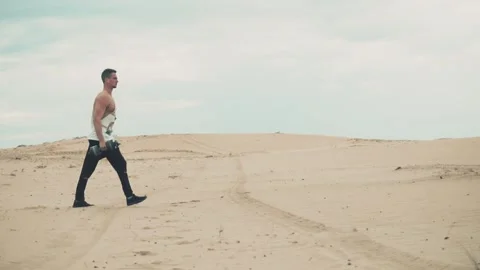 Man with dumbbells in desert Stock Footage 90486643