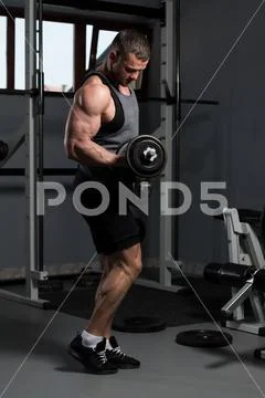 Man With Dumbbells Exercising Biceps Stock Photos