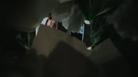 The man dumps a basket full of garbage. Bottom view from the trash bin Stock Footage 172419770