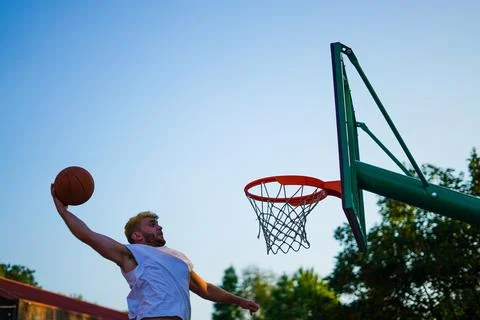 Man dunking on a basket Stock Photos