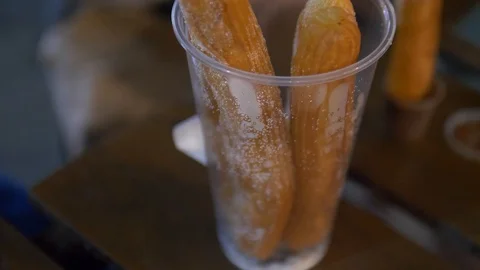 Man dunks churros in sauce Stock-Footage 124977220