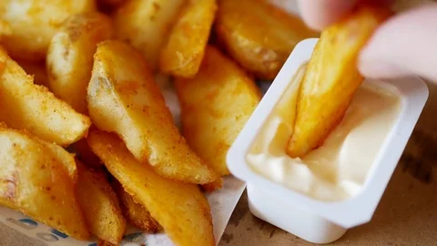 Man dunks a piece of fried potatoes in the sauce. Time lapse. Stock Footage 70402732
