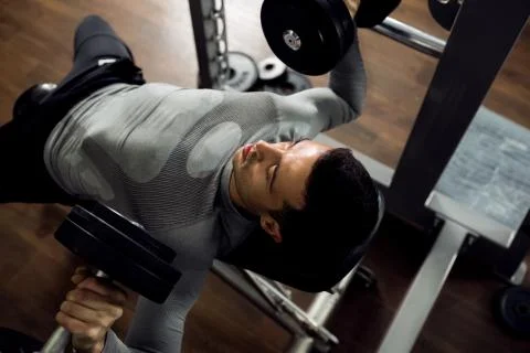 Man during bench press exercise Stock Photos