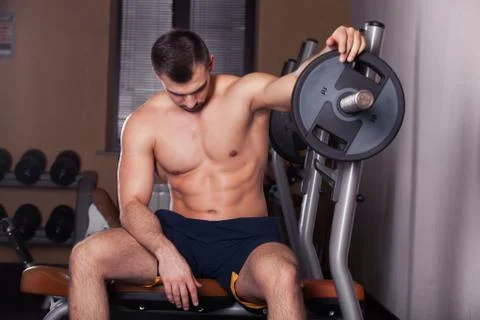 Man during bench press exercise in gym. Stock Photos