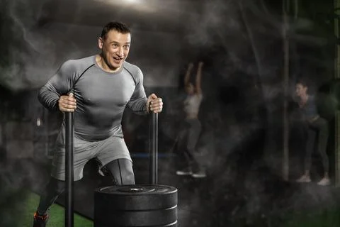 Man during grueling workout with element of push and pull superset in fitness Stock Photos