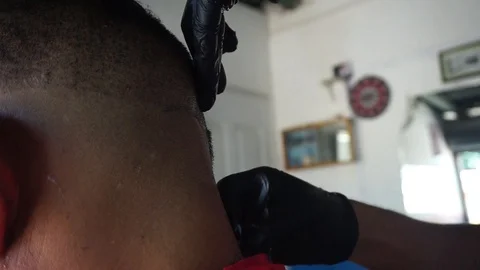 Man during haircutting process in latin barbershop Stock Footage 111234506