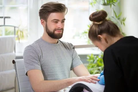 Man during manicure Stock Photos