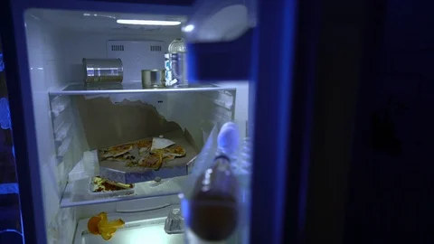 A man during self-isolation is looking for food in the fridge. Stay at home. 스톡 동영상 127428324