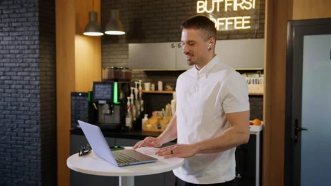 Man during a video call with colleagues on the background of an office cafe Video stock 246052207
