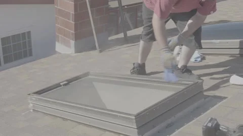 Man Dusting Off Frame of Rooftop Skylight Window (RAW) Stock Footage 212417954
