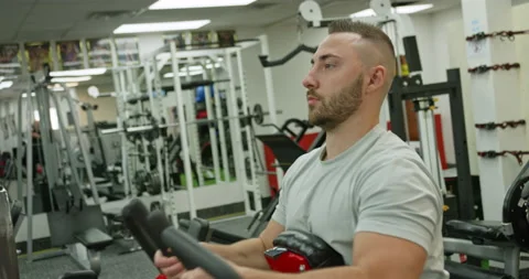 Man dusting powder on his hands as he prepares for a workout at the gym Stock Footage 230022158
