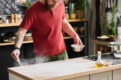 Man Dusting Table With Flour Stock Photos