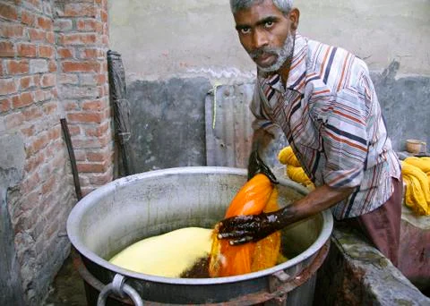 Man dyeing textile in india Stock Photos